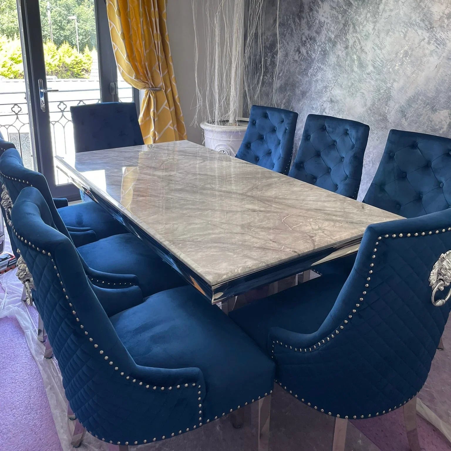Arial White Marble Dining Table With Loin Knocker Velvet Dining Chairs
